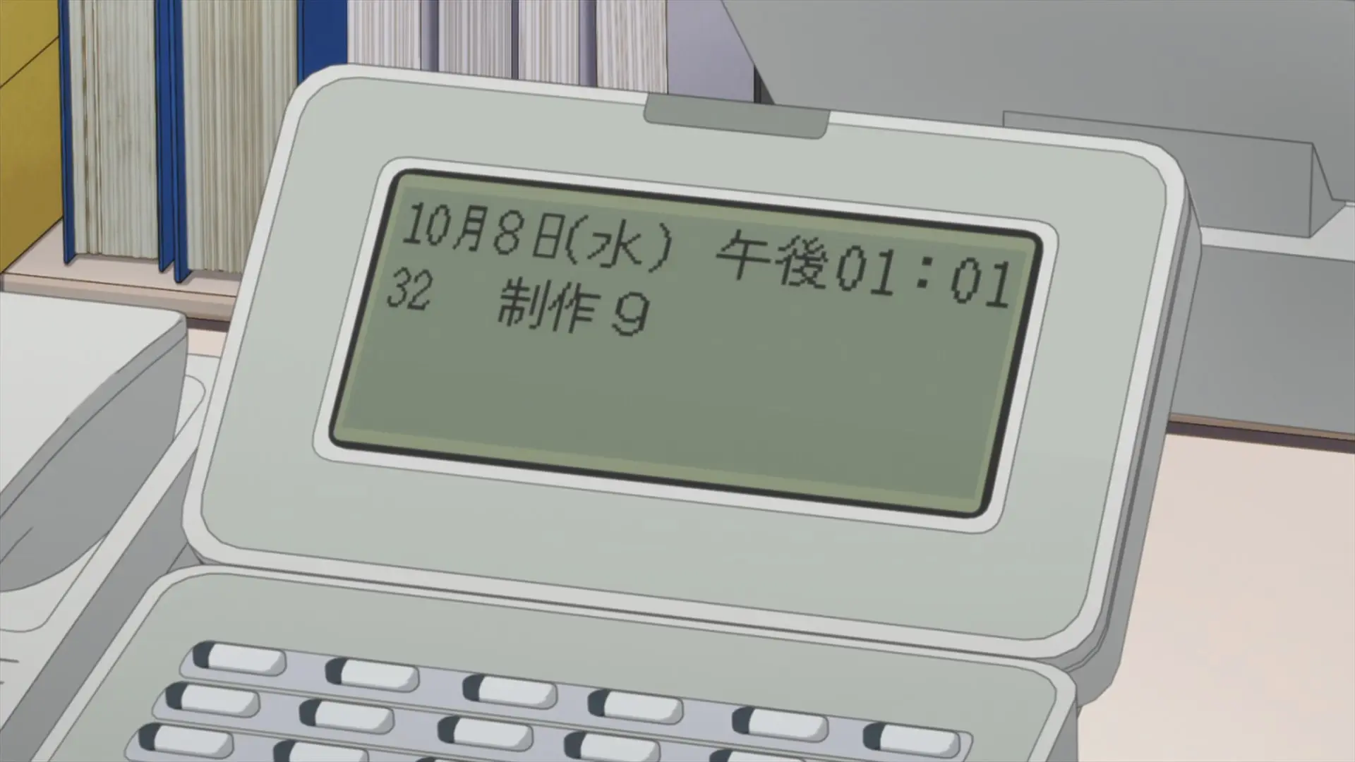 [Episode 1] Aoi's desk phone is shown, which displays the date and the day of the week: the date is the October 8 and the weekday is Wednesday.